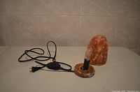 Photo of the Himalayan salt lamp base with the dimming light bulb socket, power cord, and plug.