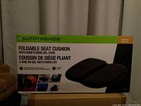 Photo of the Autotrends foldable seat cushion packaging showing front with product name, image of cushion and key features including honeycomb gel core and foldability.