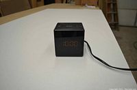 Side view of the black Sony cube digital clock radio showing the LED time display and power cord.