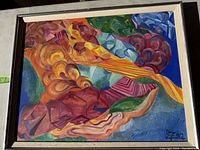 Abstract canvas art painting showing vibrant colors and shapes, framed and signed.