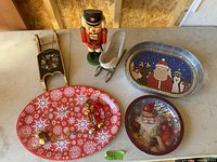 Overview image showing nutcracker, sleigh, three Christmas trays, and jingle bells.