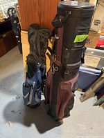 Golf travel bag and kids golf clubs standing on floor showing overall condition