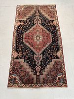 Full view of rug on floor showing overall pattern and condition