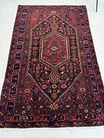 Full view of rug laid flat on floor showing overall pattern and colors