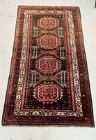 Full view of the rectangular Persian rug showing overall condition, pattern and color scheme.