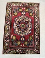 Full view of the rectangular Persian rug showing overall pattern and colors.