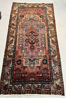 Full view of rectangular Persian rug laid flat