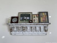 Full view of the architectural salvage floating shelf mounted on the wall with decorative items displayed on top.