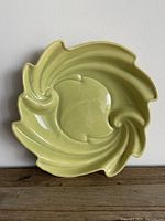 Full top-down view of the square lime green dish showing swirling design and glossy finish.