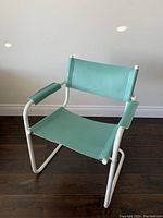 Side and angle view of turquoise cantilever chair with white tubular metal frame and turquoise fabric seat, backrest, and arm pads.