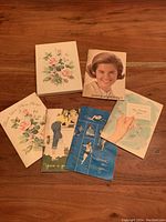 Photo showing unopened box and six vintage women's wellness booklets from the 1960s with illustrated covers in various colors and themes