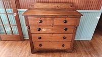 Front view showing overall chest with four drawers and two small top drawers