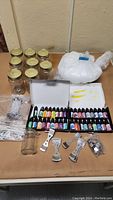 Overview of the candle making kit including jars, oil bottles, wicks and wax pellets