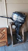 Full view of Mercury outboard motor mounted on wooden stand