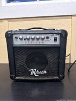 Front view of black Robson GA-15TS practice guitar amplifier with logo and speaker grille.