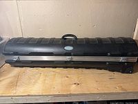 Front view of closed black SKB golf travel hard case showing overall exterior design