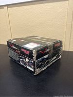 Box of V-Slides snowmobile dolly system showing top and sides with original packaging worn but box unopened.