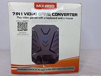 Front of the box showing device image, branding, compatibility with multiple gaming consoles (PS3, PS4, PS5, Xbox 360, Xbox One, Xbox Series, Nintendo Switch).