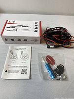 Overall kit including the camera in a rotating metal mount, wiring, manual, box, and accessory tools.