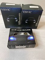 Three boxed sets of Car LED Bulbs including two VISVIC LED Headlights and one generic Car LED Bulbs box
