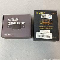 Box of Safe Bark Control Collar Model PB12 and WIEZ D020 GPS Pet Electronic Fence Equipment, showing packaging and labeling.