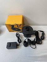 Electric air pump with three nozzle attachments, wall power adapter, car cigarette lighter adapter, and original yellow box.