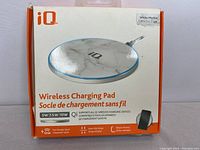 Box of IQ Wireless Charging Pad showing white marble design and product features including 5W/7.5W/10W fast charging compatibility with Qi devices