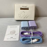 Two PD fast wall chargers, one light blue and one light purple, shown with their box and instruction manual, alongside two matching braided USB-C cables.
