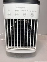 Front view of USB Cooling Fan showing control buttons and grill with LED indicators on and a USB cable plugged in.