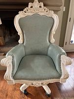 Front view showing full chair, wood frame, upholstery, base and casters