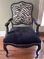 Front view of chair showing full frame, zebra back, and black velvet seat