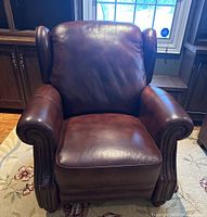 Front view of recliner showing overall shape, color, and cushion condition