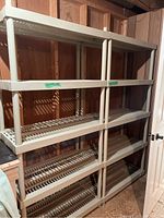 Two units stacked side by side forming a large shelving structure against a basement wall.