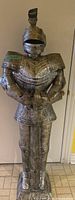 Front view of full knight suit sculpture