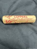 Close-up of the full paper roll with printed text noting "50¢ COPPERS" and bank details.