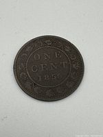 Reverse side showing denomination 'ONE CENT' with date '1859' and wreath design.