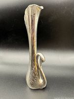 Front view of a small metallic swan bud vase showing its detailed swan form and silver tone finish.