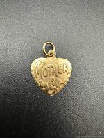 Heart-shaped 24k gold pendant charm with 'Mother' engraved and floral design on front.