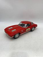 Red 1963 Corvette Stingray decanter angled front side view showing car shape and front end details.