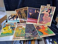 Full view of all 8 art nouveau posters laid out, showing variety of subjects and vibrant colors.