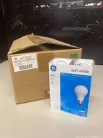 Box with 48 count of GE soft white 60 watt light bulbs.