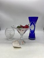 Front photo showing all three items: blue etched crystal vase, pedestal dish with beaded strawberries, and small clear crystal vase.