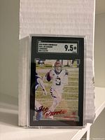 Front view of Joe Burrow football card graded 9.5 by SGC with serial numbering and card details displayed.