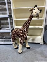 Full side view showing overall size and pattern of the plush giraffe.