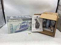 Rowenta iron box next to open box containing My Little Steamer and accessories