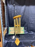 Full view of Majestic Bells wind chimes on Bon-Ton metal wreath stand with original box in the background.