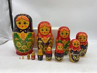 Full set of 12 Russian nesting dolls arranged in order of size, largest to smallest, showing floral paint and color scheme.