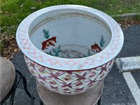 Top view of porcelain bowl showing interior koi fish motif and rim decoration.