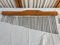 Full length view of LP 36 bar studio musical wind chimes with 35 metal bars suspended from wood frame.