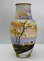 Front view of Nippon hand painted bisque finish vase with tree and house scenic design